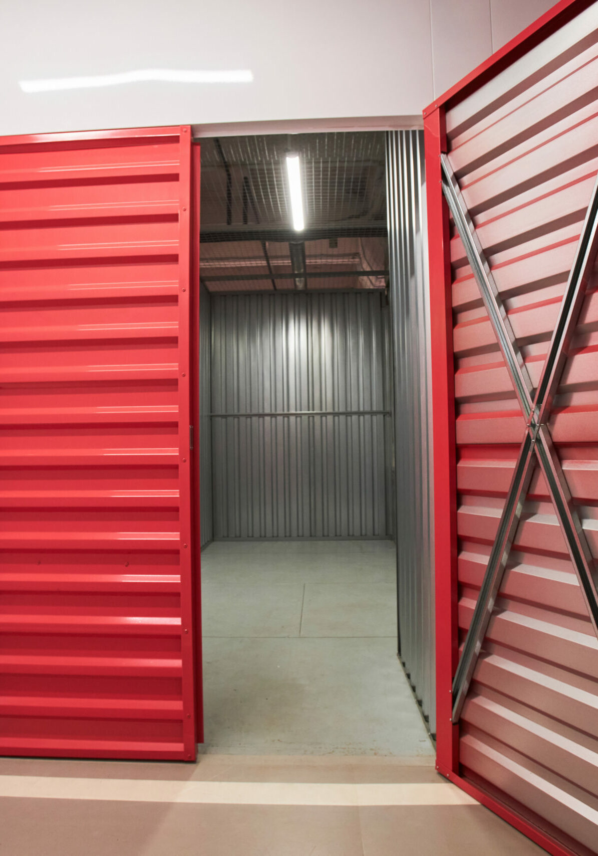 Opened doors of empty self-facility storage unit prepared for customer